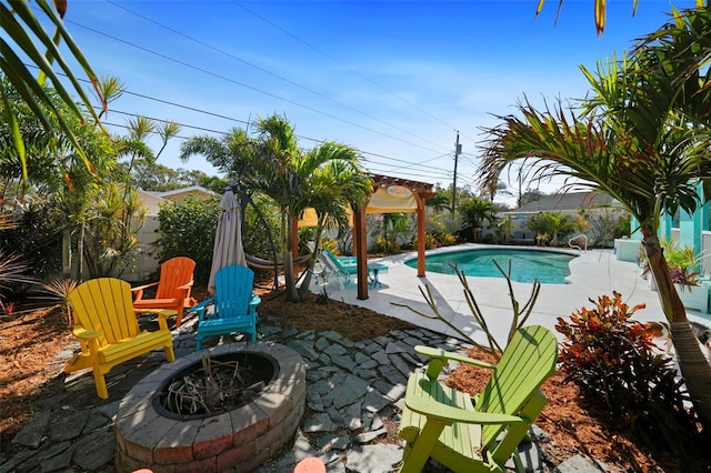 9911 Antilles Dr, Seminole, FL 33776 - view of swimming pool featuring a patio area, an outdoor fire pit, a fenced in pool, and a fenced backyard
