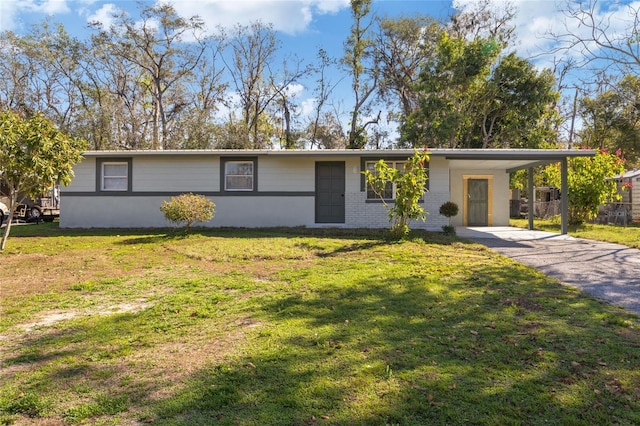 ranch-style home featuring a carport and a front yard