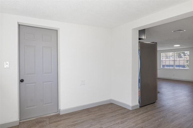 spare room featuring hardwood / wood-style floors