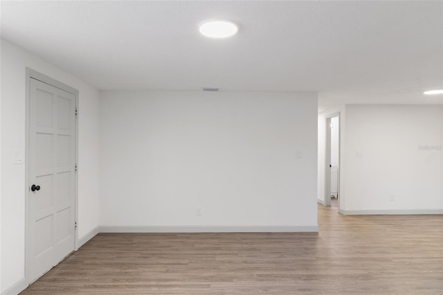 spare room featuring light hardwood / wood-style flooring