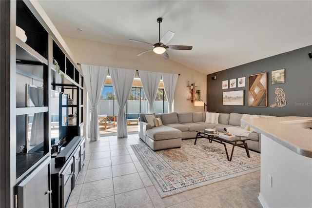 tiled living room with ceiling fan and vaulted ceiling