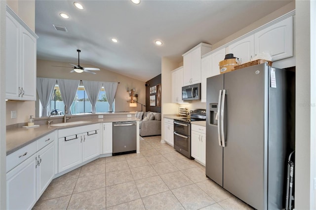 kitchen featuring white cabinetry, sink, stainless steel appliances, and light tile patterned floors