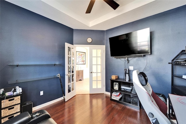 interior space featuring a raised ceiling, ceiling fan, french doors, and dark hardwood / wood-style flooring