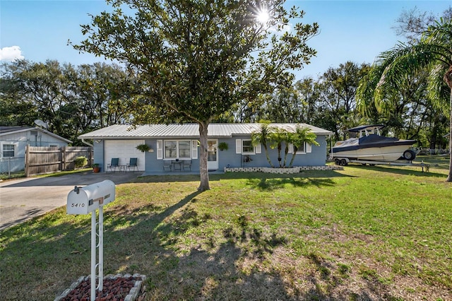 ranch-style home with a garage and a front lawn