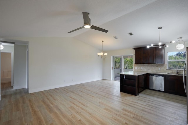 kitchen with dishwasher, lofted ceiling, dark brown cabinets, and a healthy amount of sunlight