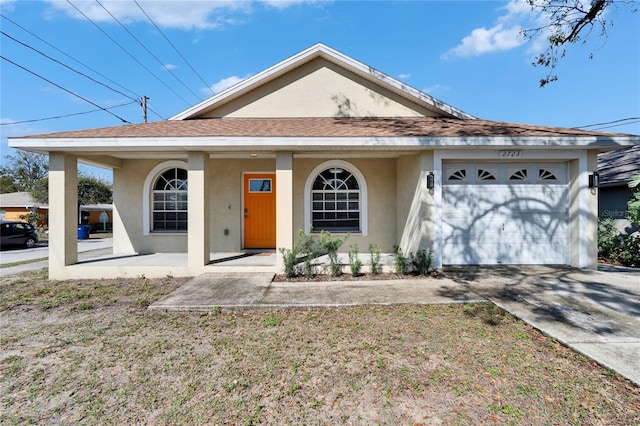 ranch-style house with a garage, a front yard, and covered porch