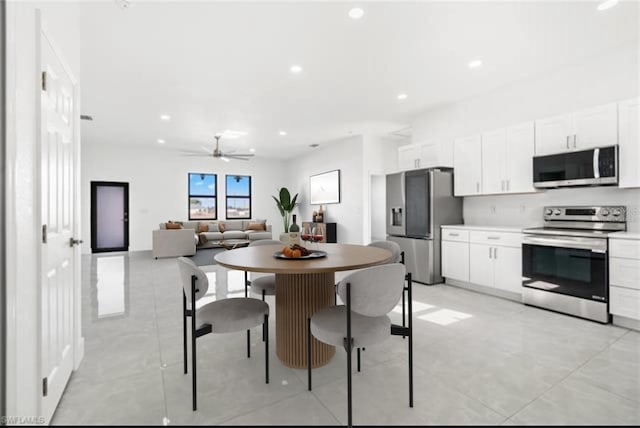 kitchen with stainless steel appliances, recessed lighting, white cabinets, and ceiling fan