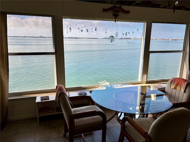 interior space with plenty of natural light and a water view