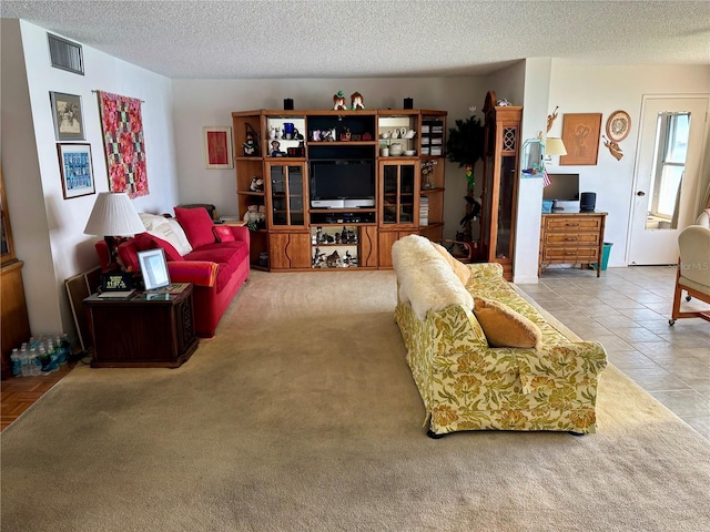 tiled living area with visible vents and a textured ceiling