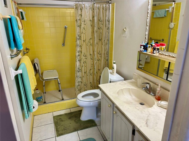 full bathroom featuring tile patterned flooring, vanity, a shower stall, and toilet