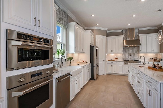 kitchen featuring stainless steel appliances, sink, white cabinets, and wall chimney exhaust hood