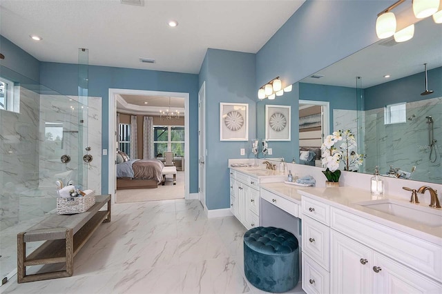 bathroom featuring vanity, a notable chandelier, and tiled shower