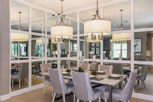 dining area featuring ornamental molding and a notable chandelier