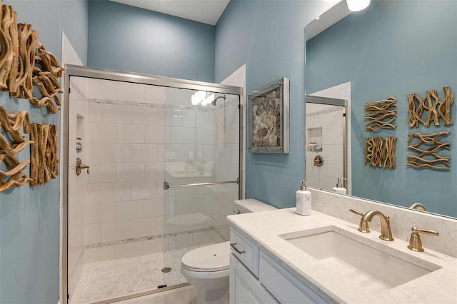 bathroom featuring walk in shower, vanity, and toilet