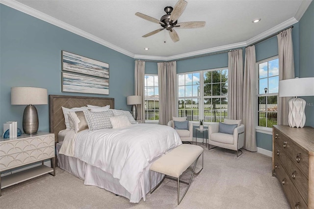 carpeted bedroom featuring ceiling fan, ornamental molding, and a textured ceiling