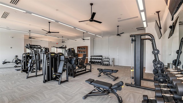 exercise room with light carpet and ceiling fan