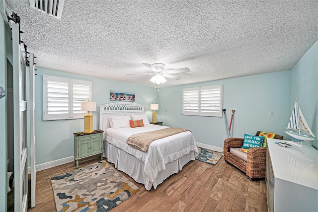 13614 Evelane Dr, Hudson, FL 34667 - bedroom with multiple windows, baseboards, and light wood-type flooring