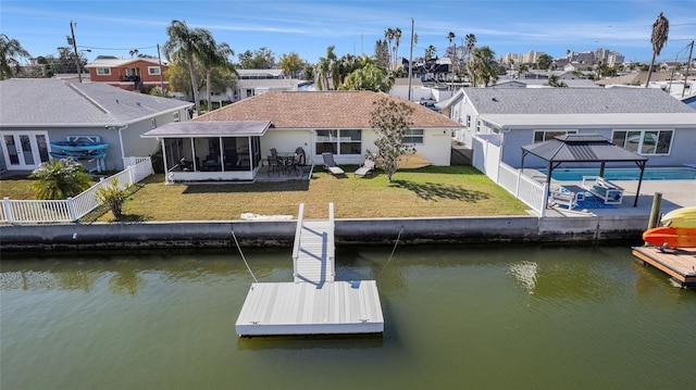 13614 Evelane Dr, Hudson, FL 34667 - rear view of house featuring a sunroom, a water view, a patio, and a residential view