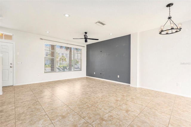 empty room featuring ceiling fan with notable chandelier, light tile patterned floors, recessed lighting, and baseboards