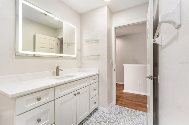 bathroom with vanity and baseboards