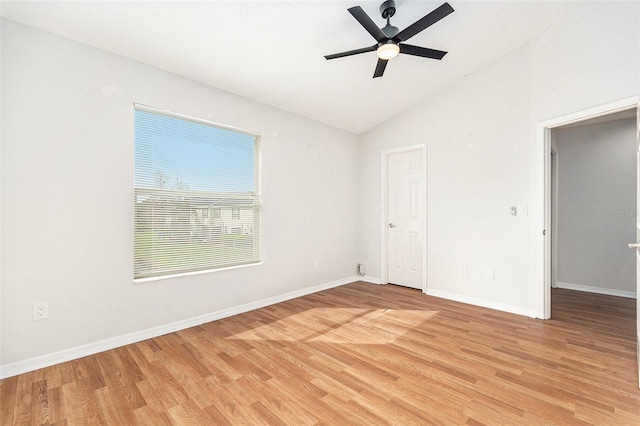 unfurnished bedroom with lofted ceiling, light wood-type flooring, a ceiling fan, and baseboards