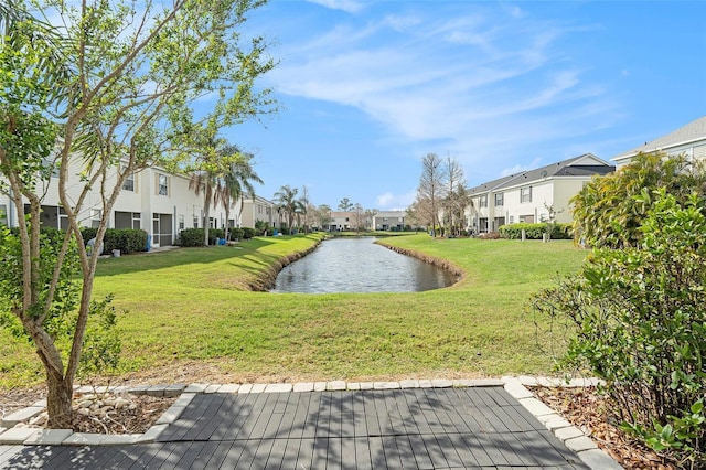 view of property's community featuring a residential view, a water view, and a lawn