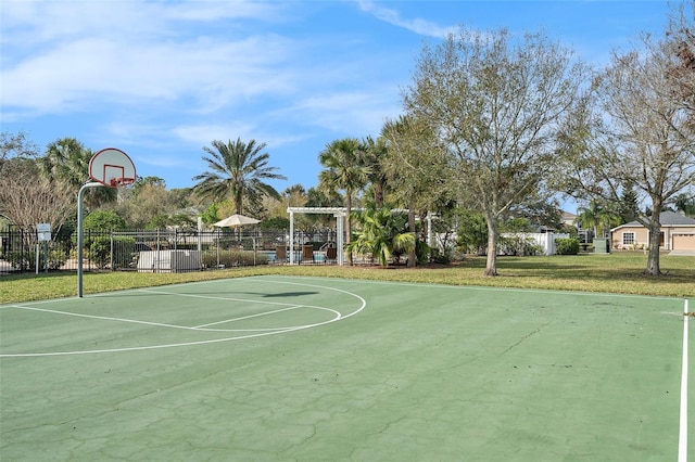 view of sport court featuring community basketball court, fence, a pergola, and a yard