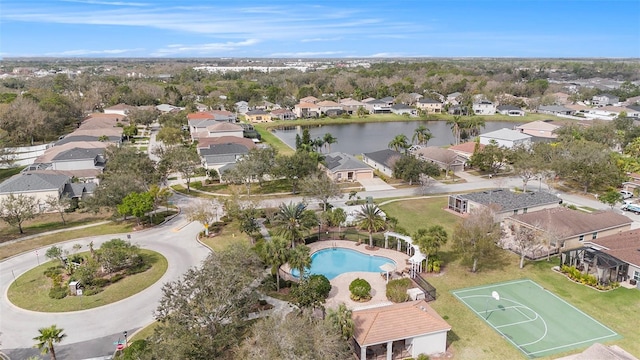 drone / aerial view featuring a water view and a residential view