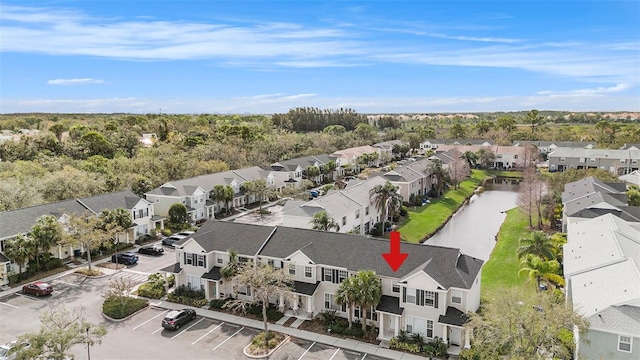 birds eye view of property featuring a water view and a residential view