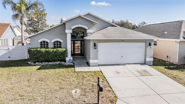 view of front of house featuring a garage and a front yard