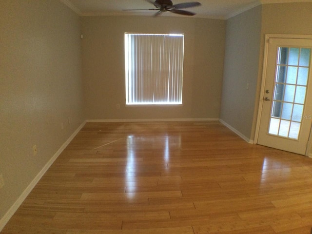 unfurnished room featuring ornamental molding, ceiling fan, and light wood-type flooring