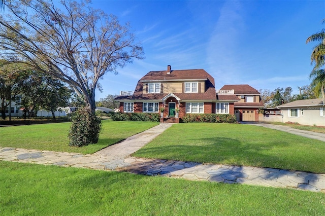 view of front of property featuring a chimney, an attached garage, a gambrel roof, a front yard, and driveway