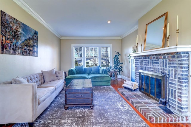 living area featuring ornamental molding, a brick fireplace, baseboards, and wood finished floors