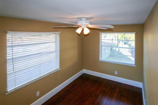 unfurnished room with dark wood finished floors, baseboards, and ceiling fan