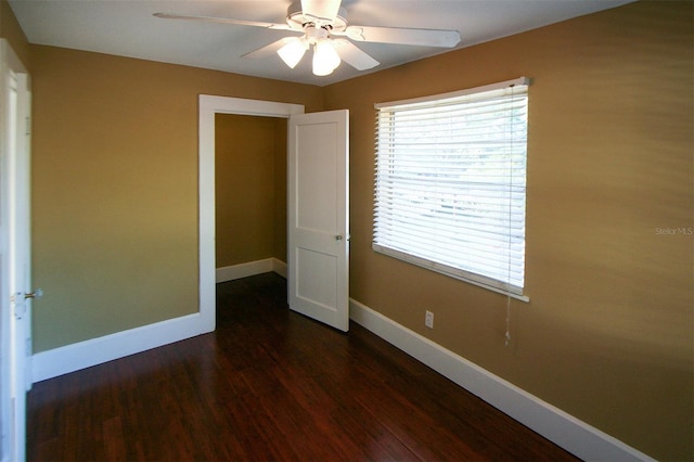 spare room featuring a ceiling fan, baseboards, and wood finished floors