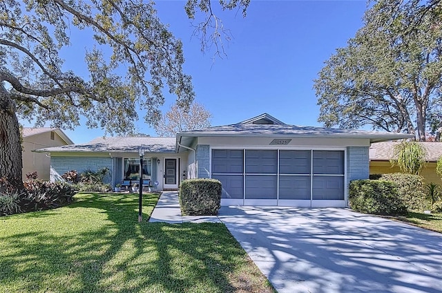 ranch-style home with a garage and a front lawn