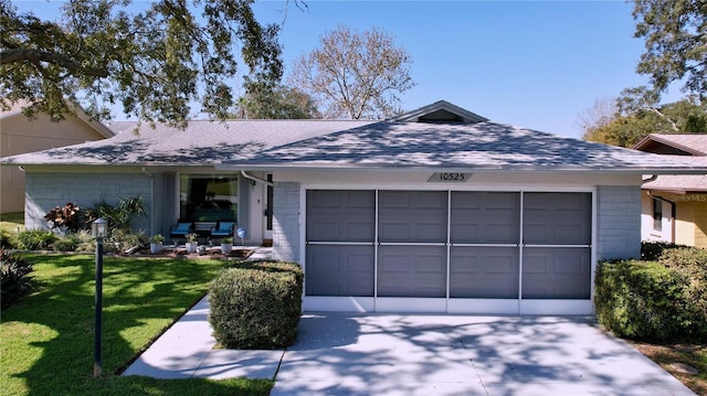 single story home featuring a garage and a front lawn