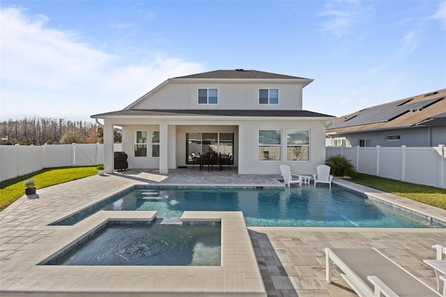 back of house with a pool with hot tub and a patio