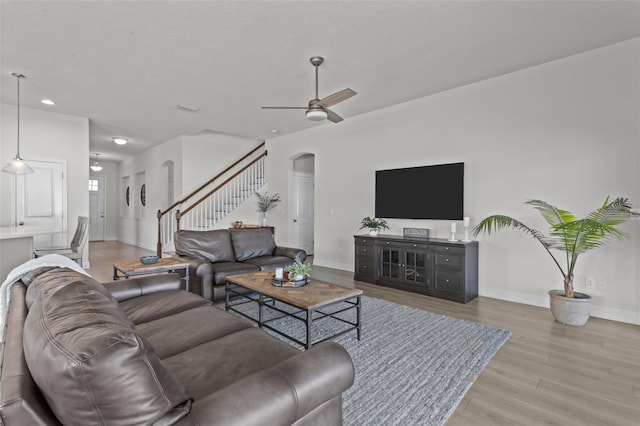 living room with hardwood / wood-style floors and ceiling fan