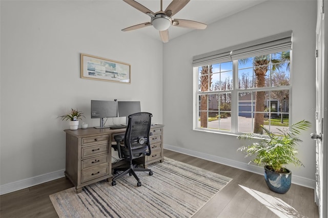 home office with dark wood-type flooring and ceiling fan