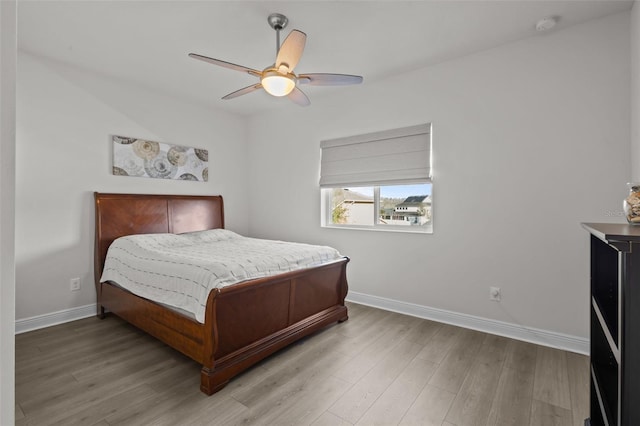 bedroom with ceiling fan and light wood-type flooring