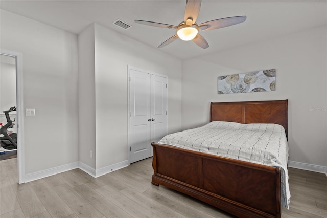 bedroom with a closet, ceiling fan, and light hardwood / wood-style flooring