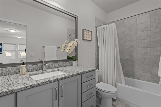 full bathroom featuring vanity, shower / bath combo, and toilet