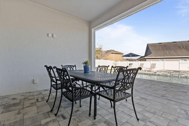 view of patio with an in ground hot tub