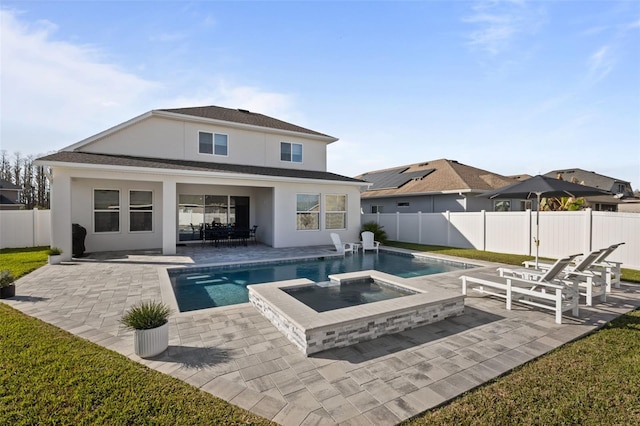 rear view of house with a pool with hot tub and a patio area