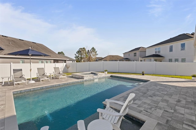 view of swimming pool featuring an in ground hot tub and a patio