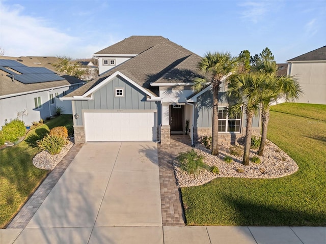 view of front of house with a garage and a front lawn