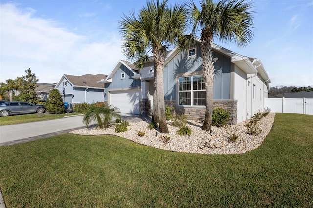 view of front of house with a garage and a front lawn