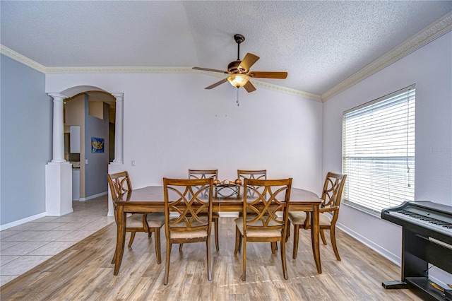 dining room with ornate columns, ceiling fan, crown molding, a textured ceiling, and light hardwood / wood-style flooring