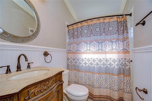 bathroom featuring vanity, a textured ceiling, ornamental molding, and toilet